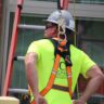 man on a ladder using protective equipment