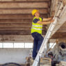 Construction site builder climbing on ladder